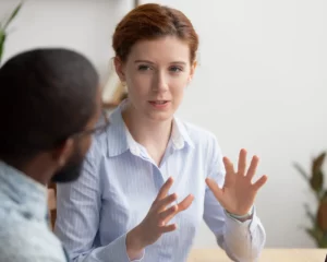 Female affiliate marketing mentor explaining strategy to a male mentee